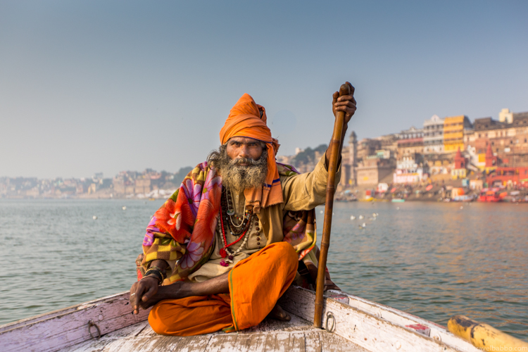 India photography trips: A Sadhu (holy man) on the River Ganges in Varanasi, India. Piper asked him to ride with us on our boat so that we could photograph him.