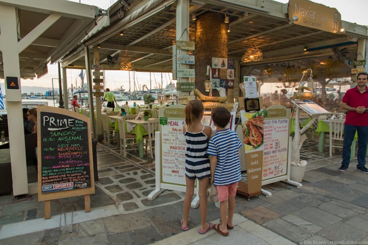 Greece with kids: The kids making the final decision on dinner based on the menu