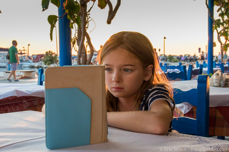 Favorite Travel Products - Kindle - Engrossed in Harry Potter and the Deathly Hallows while waiting for dinner in Naxos, Greece