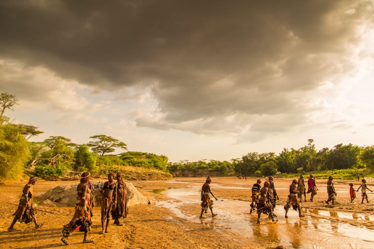 Ethiopia travel: Hamer people crossing the Keske River, heading home from the bull jumping
