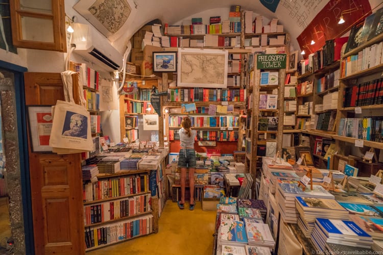 Benefits of traveling with kids: My oldest daughter in heaven at Atlantis Books in Oia, Santorini