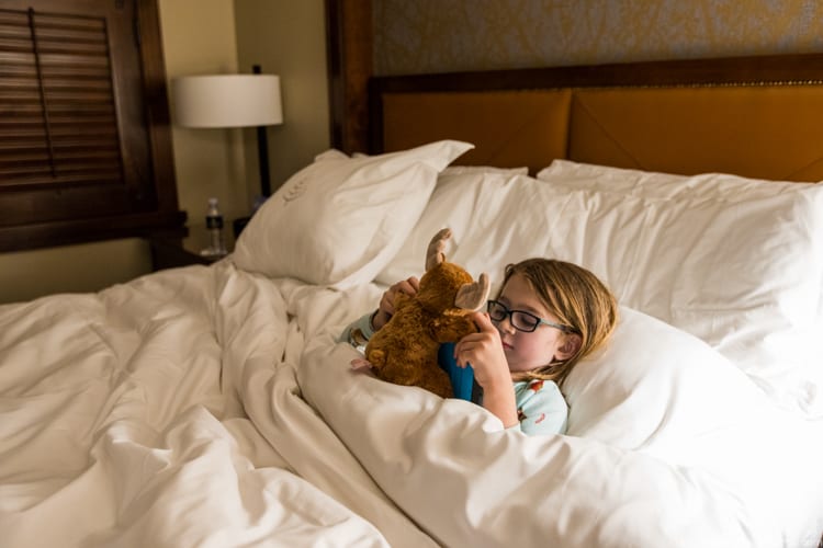 Jackson Hole with Kids: All tucked in at the Four Seasons, watching cartoons with her new moose friend