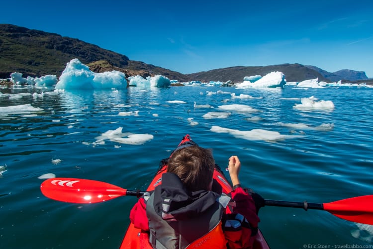 Greenland with kids - Kayaking while holding sea ice