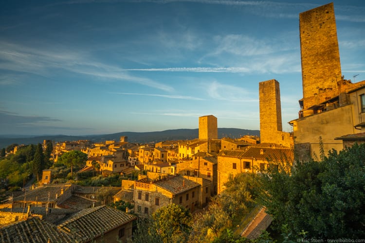 How to fly a lot - Sunrise in San Gimignano, Italy, partway through our 90km hike on the Via Francigena 