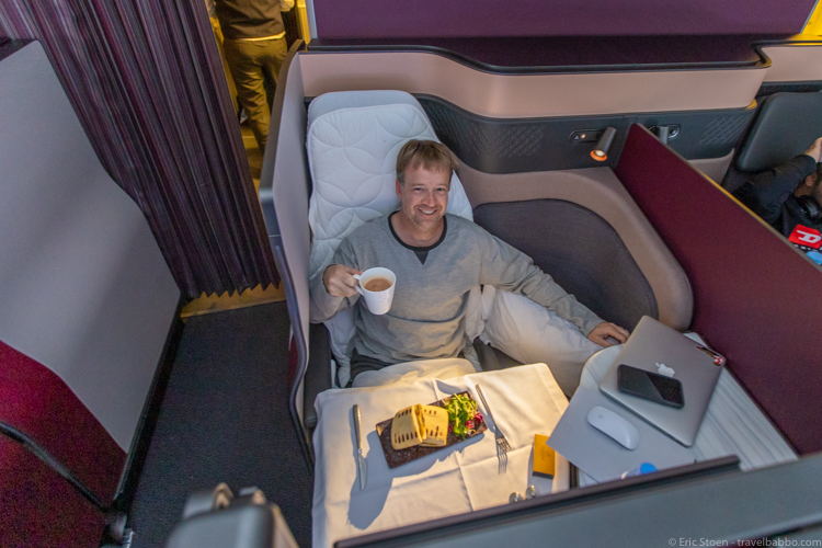 Qatar Airways Qsuite - On the return flight - having a pre-landing snack in my Qatar Airways pajamas 