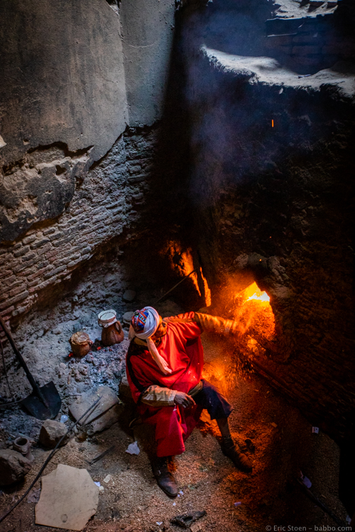 Morocco with Kids - A hammam worker keeping the fire going