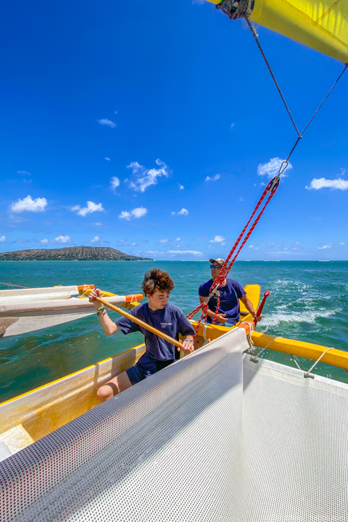 Things to do in Oahu: Helping to paddle the sailing canoe