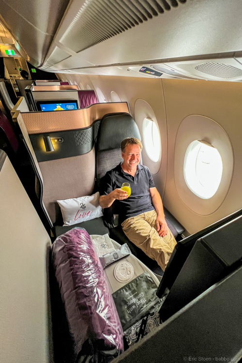 In the Qatar Airways QSuite. You can redeem American miles for tickets, but I've found it works better to transfer miles from my British Airways account to my Qatar Air account and then redeem the miles directly